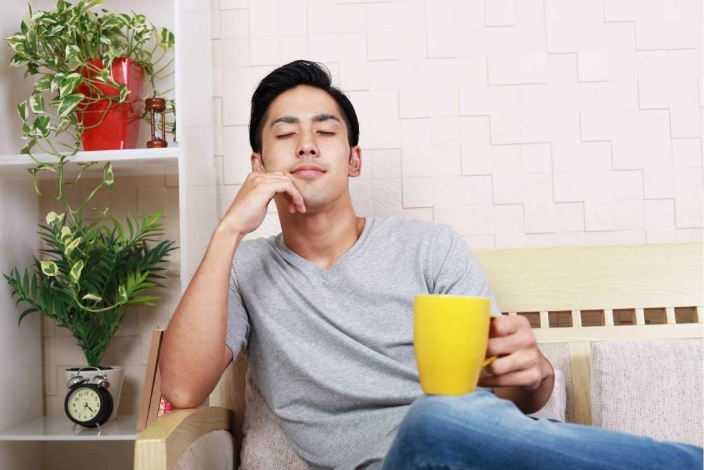 Man Relaxing with a Yellow Cup