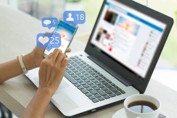 Hands Scrolling on Social Media Phone and Laptop with Notifications