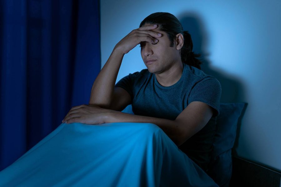 Tired Man with Hand on Head Suffering with Insomnia