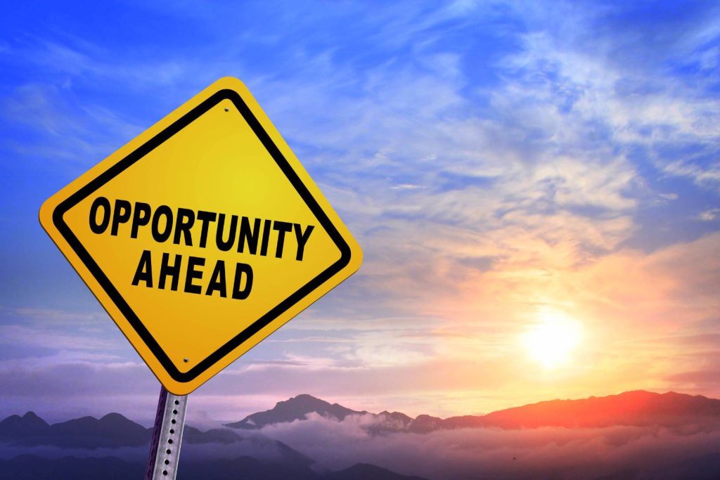 Opportunity Ahead Sign with Beautiful View of Sky, Sunset, and Mountains