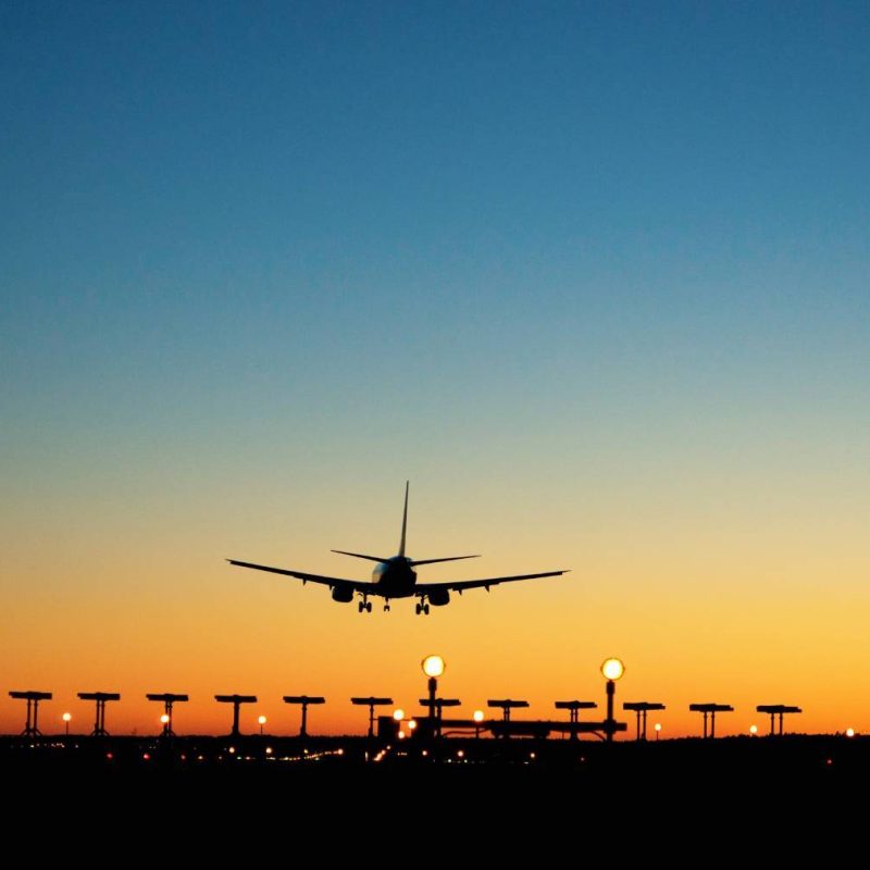 Plane Landing Safely at Airport During Sunset