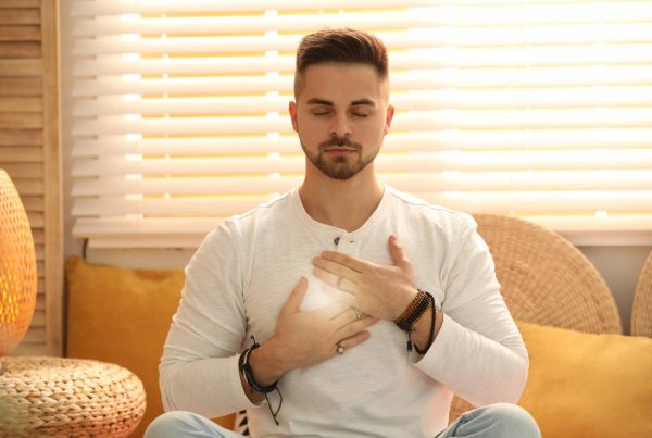 Man Holding Powerful Heart Being Self-Compassionate