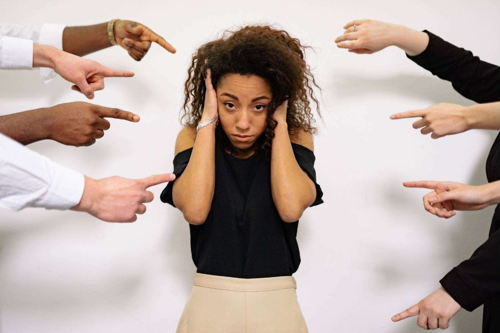 Woman Under Pressure with Fingers Pointing at Her