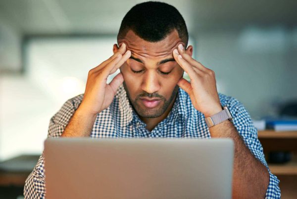 Man Stressed with Hands on Head Headache