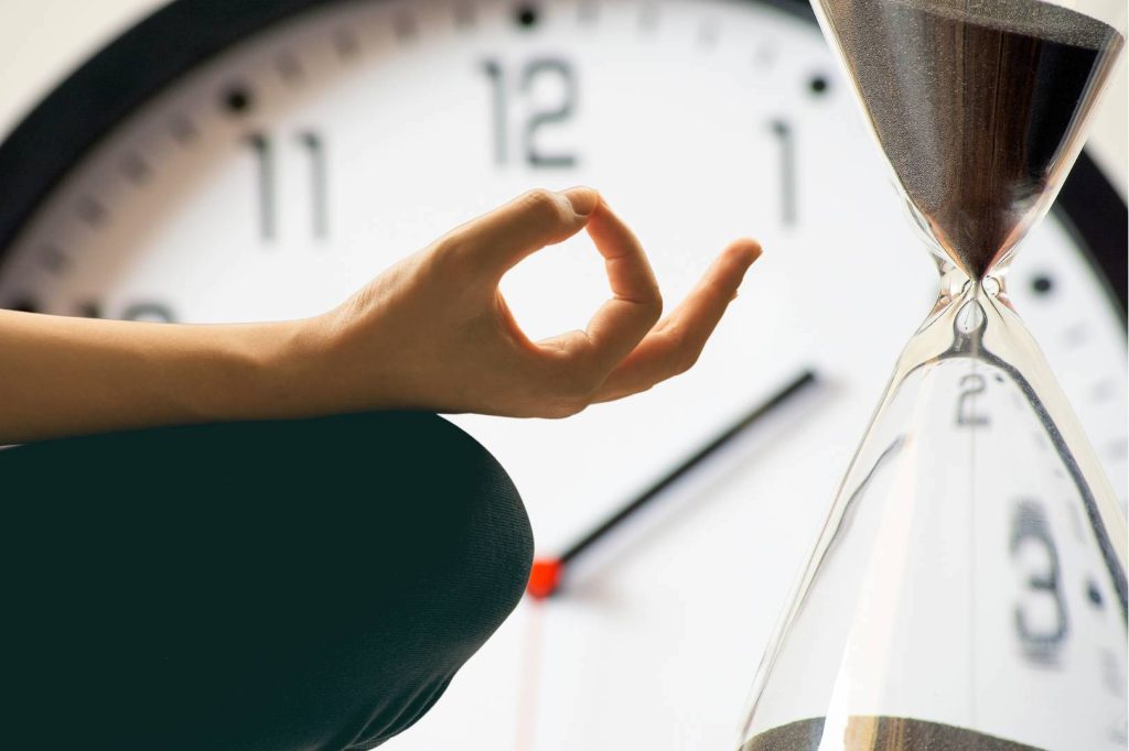 Meditating Hand With Timer and Hour Glass