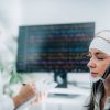 Woman Meditating with Scientist Measuring Brainwaves with EEG Helmet