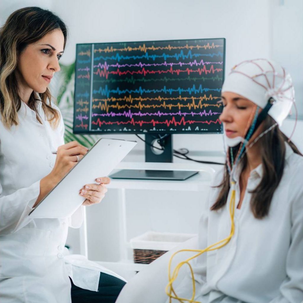 Scientist Measuring Brain Waves of Woman Meditating Using EEG Device